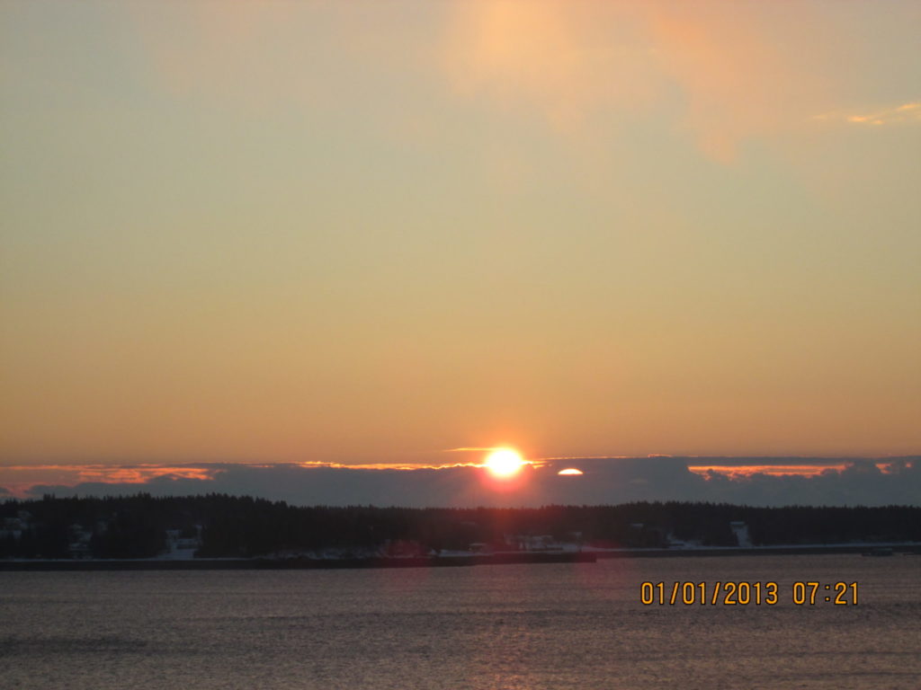 View of sun appearing over Campobello Island from Eastport Maine