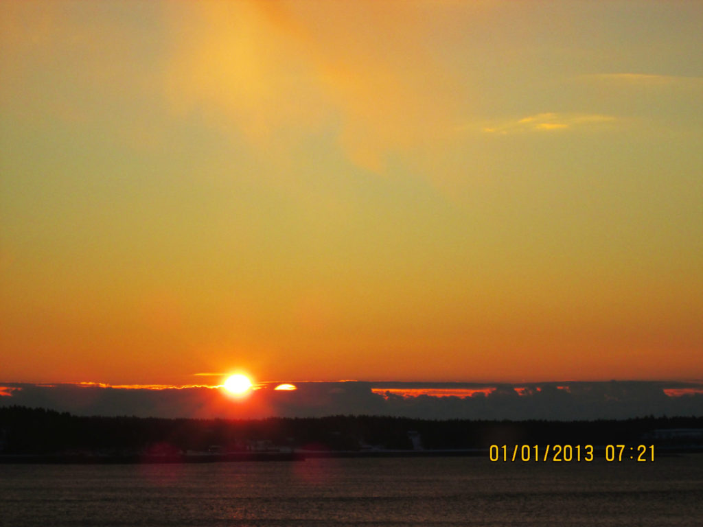 View of sun appearing over Campobello from Eastport Maine