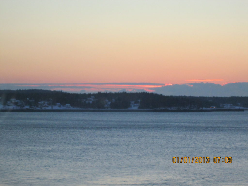 View of sun rising over Campobello Island from Eastport Maine