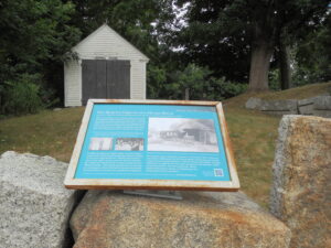 Walking Tour sign and Hearse House by Old Burial Ground Essex, Mass.