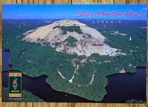 Postcard with aerial view of Stone Mountain with lake